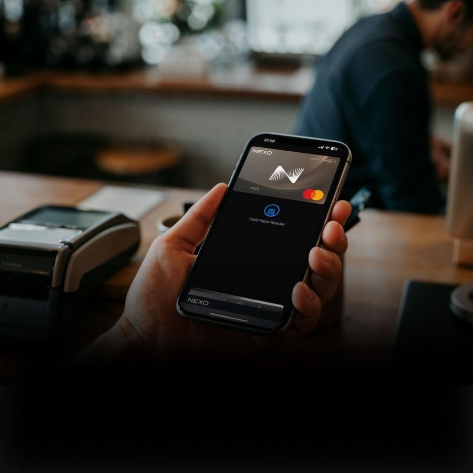 Contactless payment via a crypto-linked credit card.